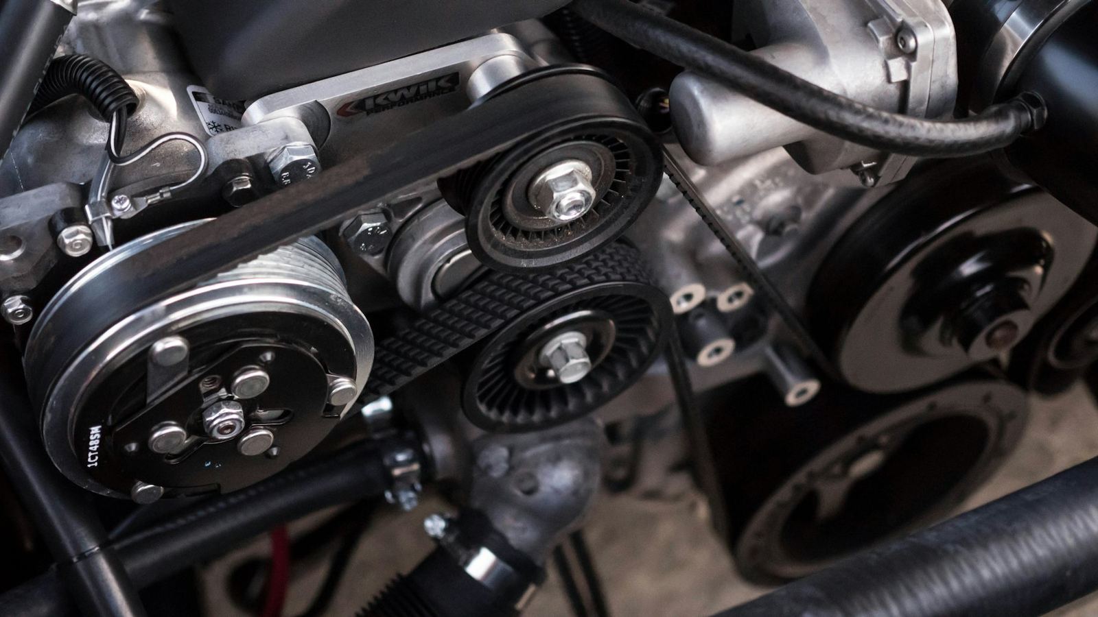 Close-up of an engine's drive belt and pulleys. Stock photograph.